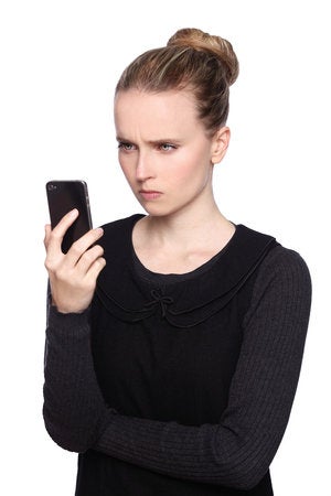 Shutterstock unhappy woman with mobile phone