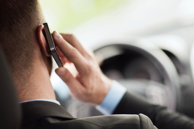 guy driving talking on phone