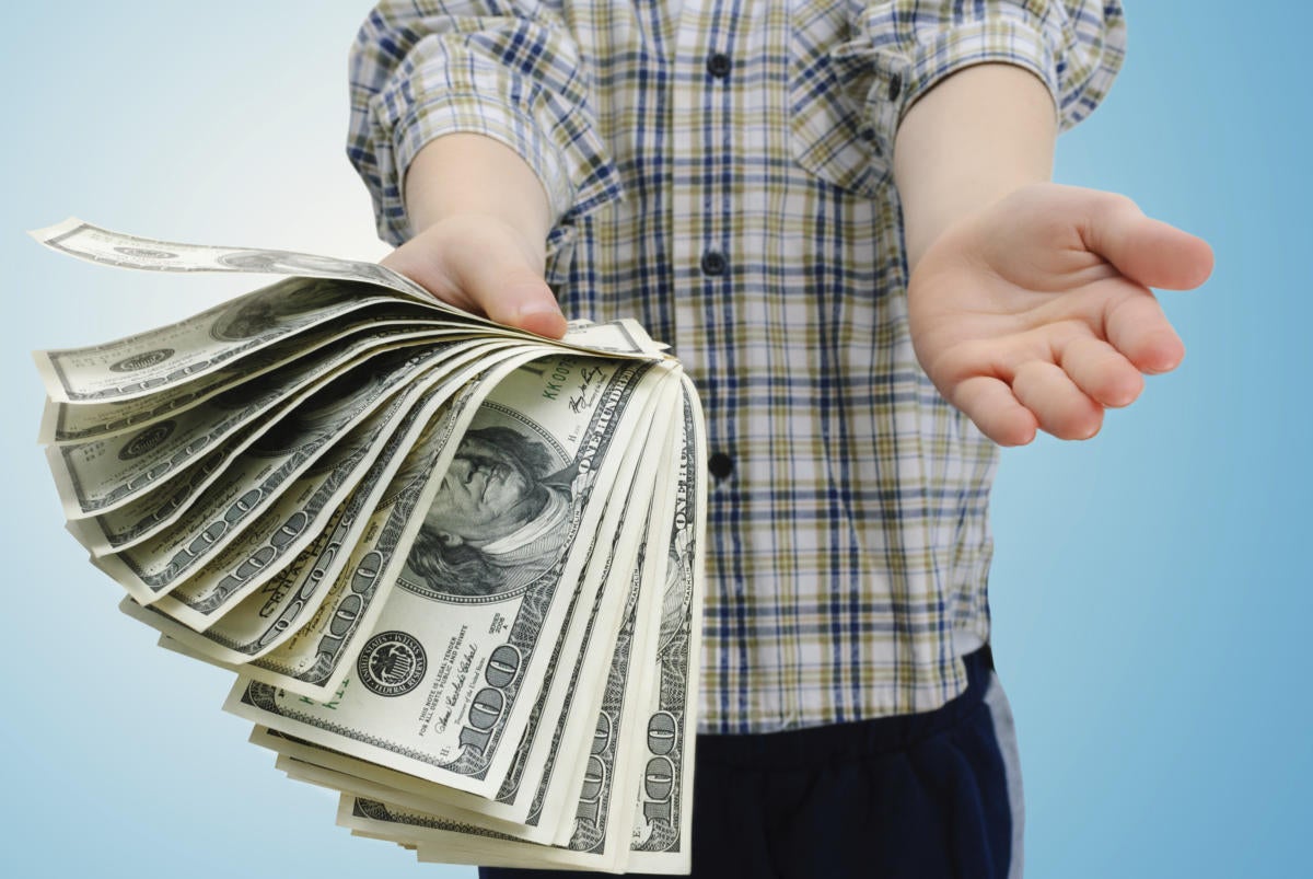 young man in plaid shirt holding pile of cash money
