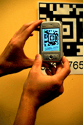 image of a cell phone scanning a 2D barcode