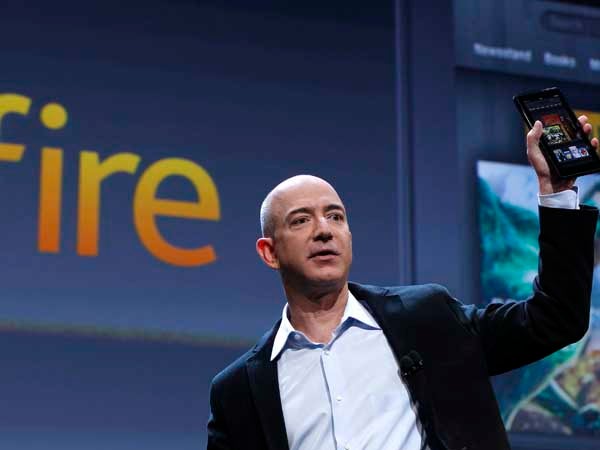 Amazon CEO Jeff Bezos holds up the new Kindle Fire