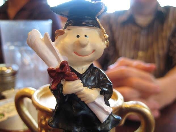 Statue of a graduate holding a diploma