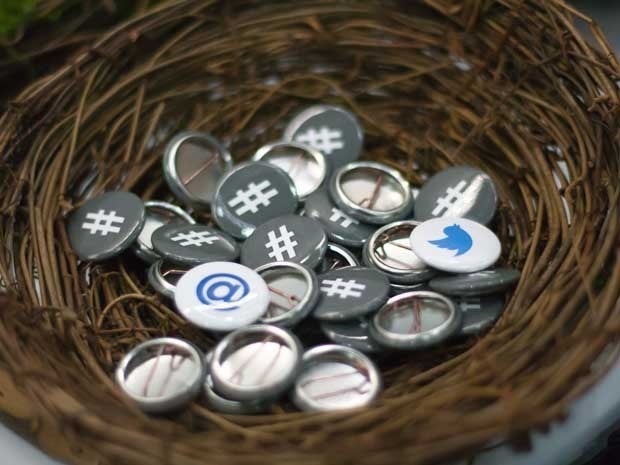Picture of a bunch of buttons with Twitter insignia on them in a bird's nest