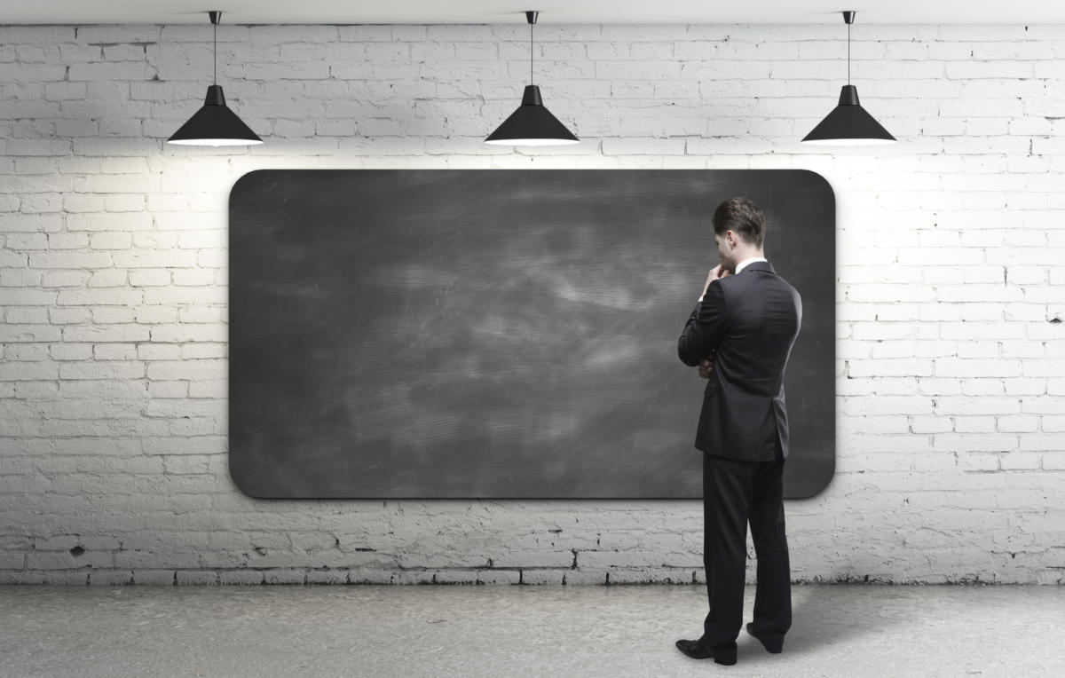 Man brainstorming at blackboard 181422978