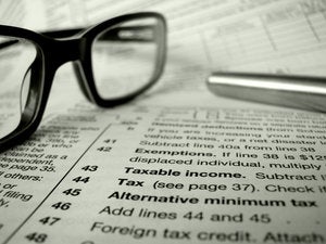 taxes forms glasses calculations fine print