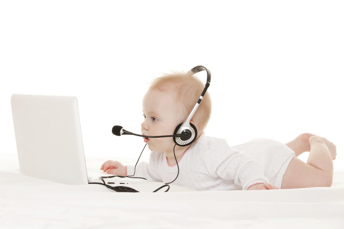 Cute baby-operator with laptop on a white bed 179243846