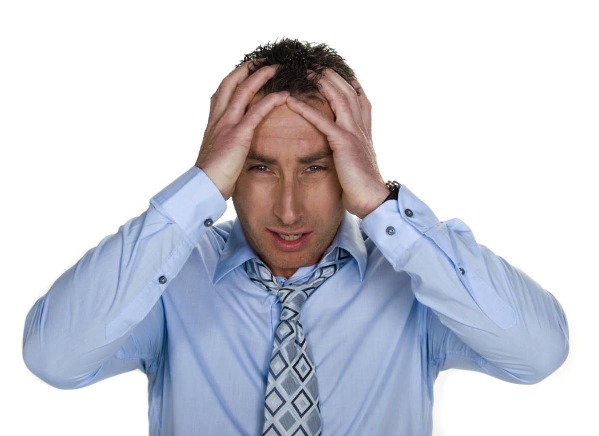 businessman with stress headache pain frustration