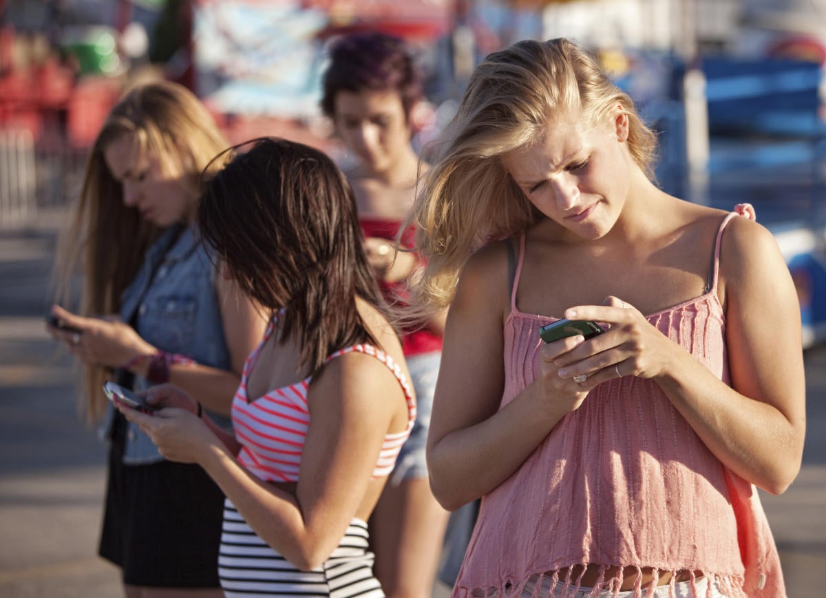 serious teenagers on smartphones 159021305