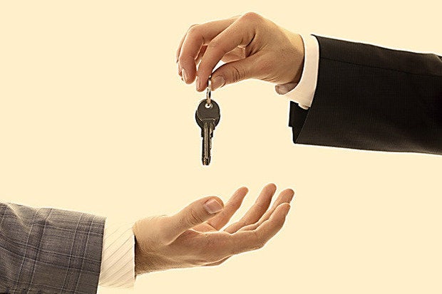 handing keys over business workers