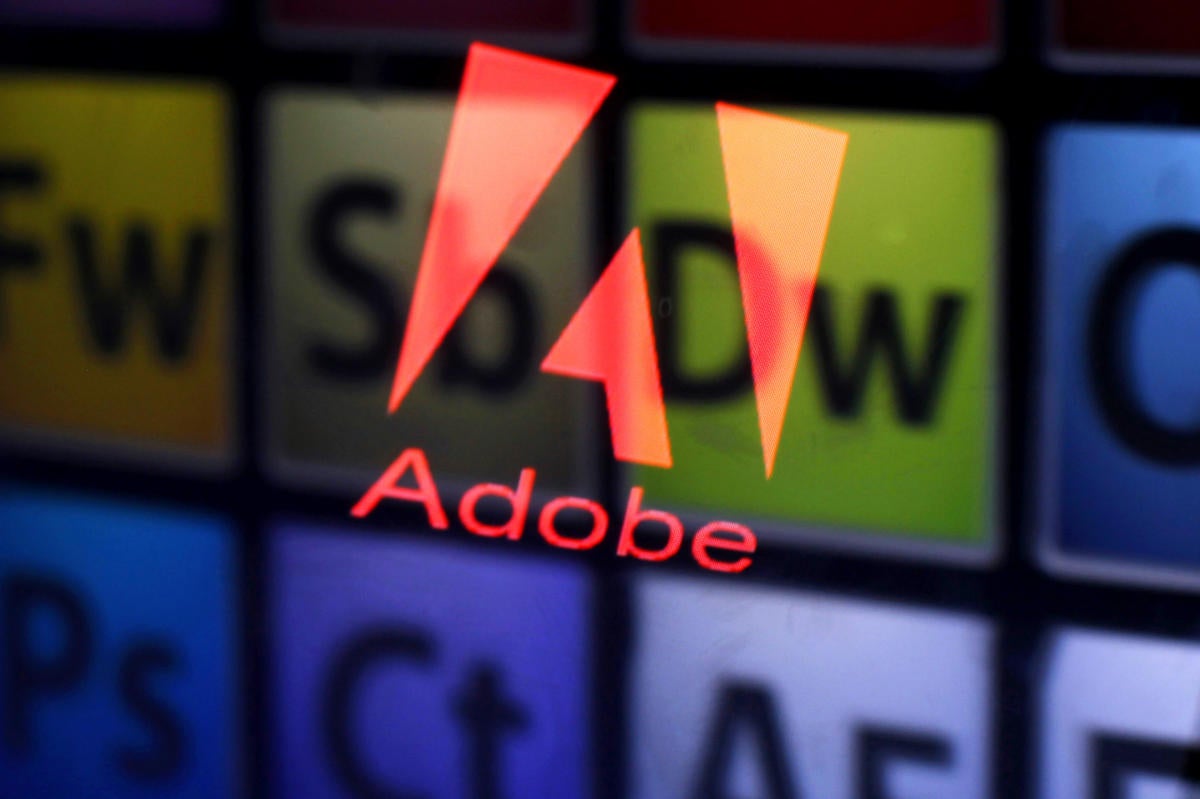 Adobe logo and products reflected in displays.