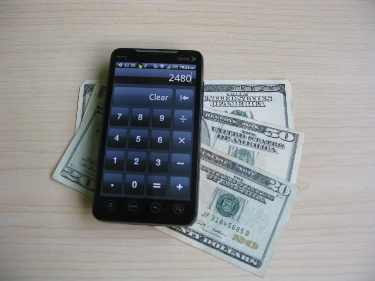 Older Android smartphone with cash
