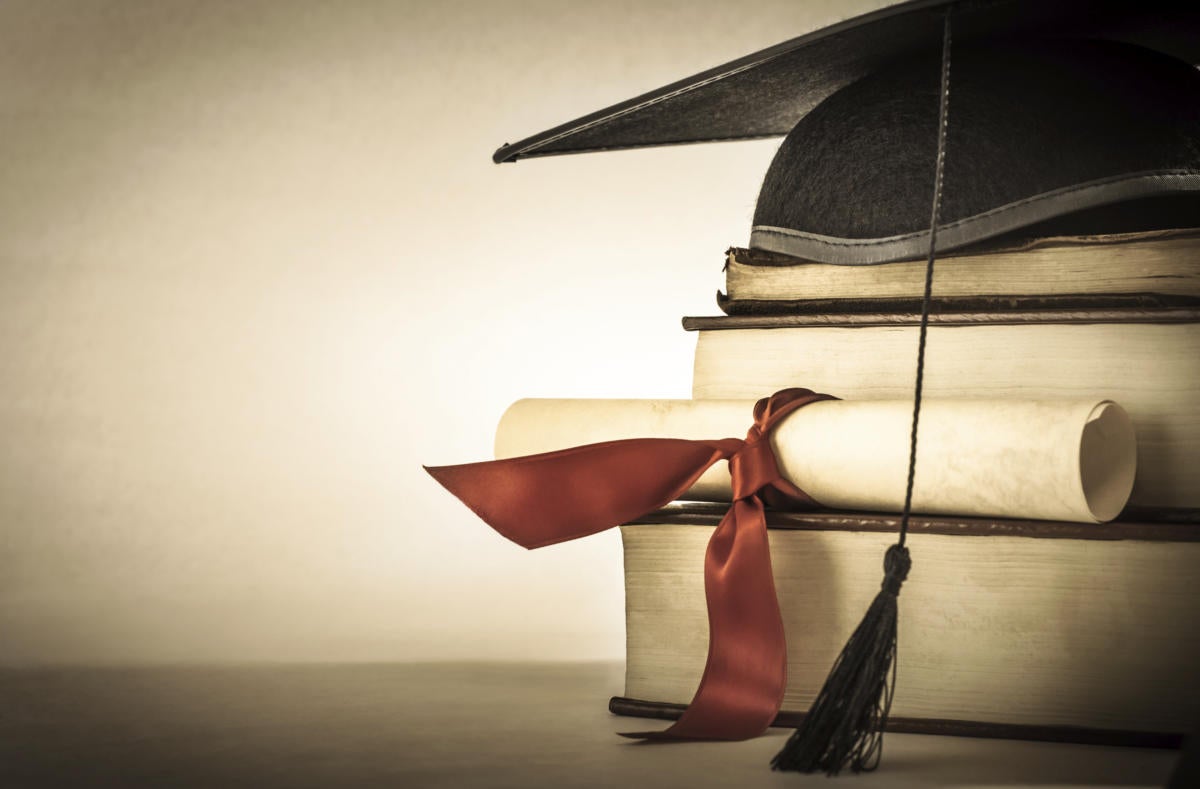 graduation cap, degree scroll and books