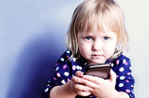 child holding cell phone baby