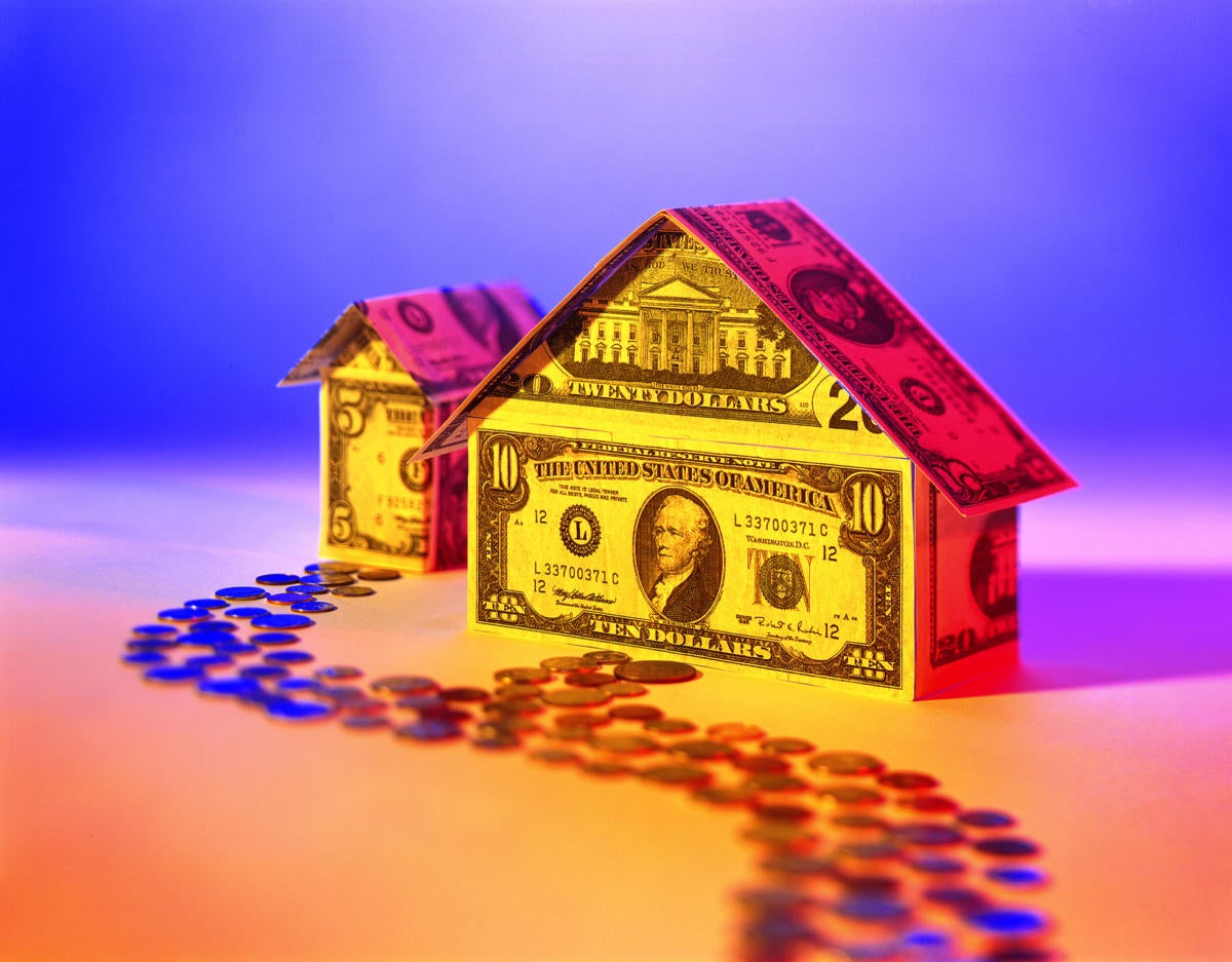 high contrast image of house made out of money as investment or money pit