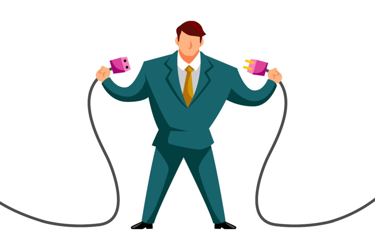 A businessman connects two power cords.