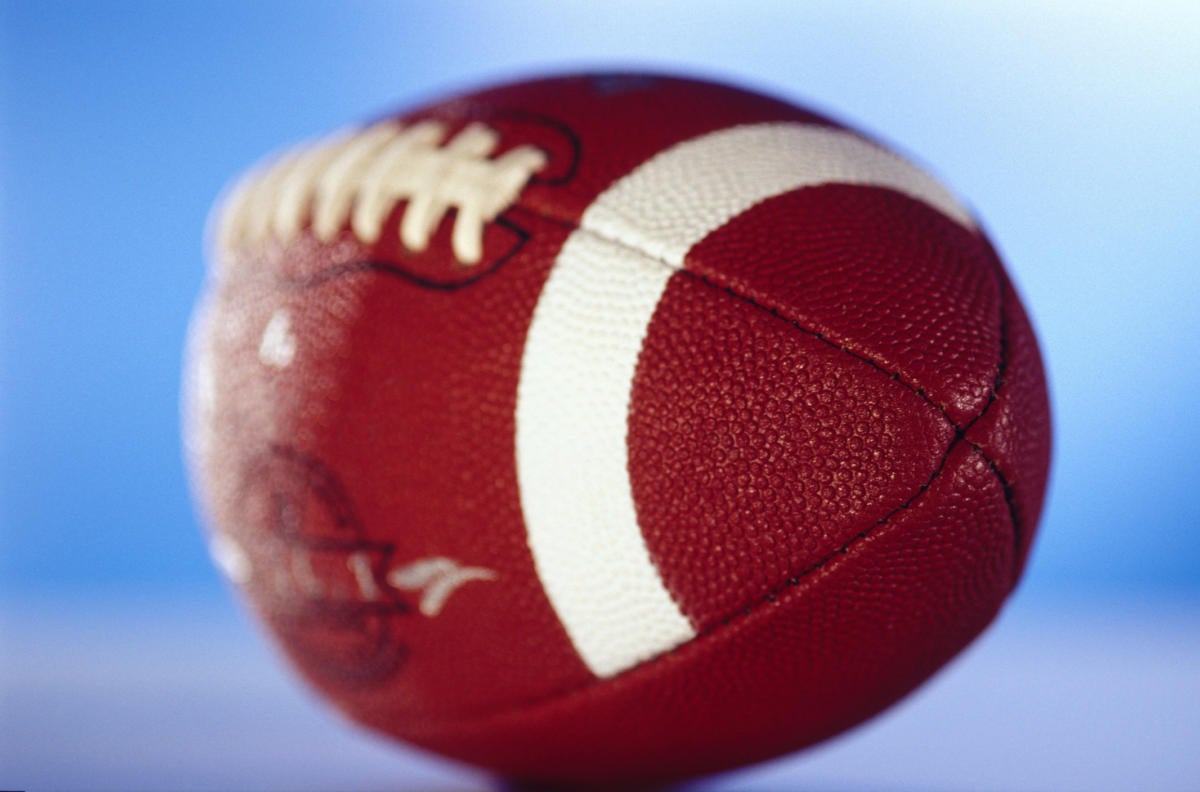 Football in soft focus against blue background