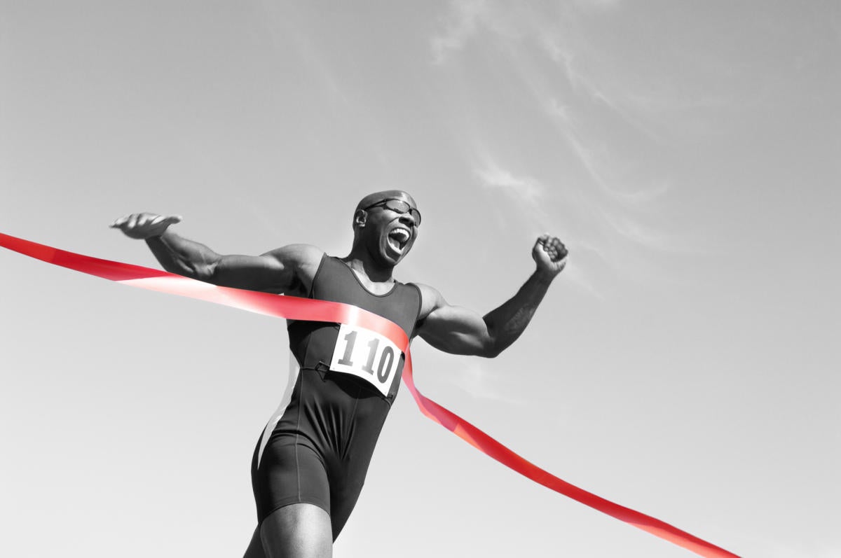 man running across finish line