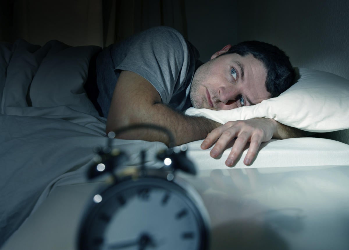 Man trying to sleep in the middle of the night