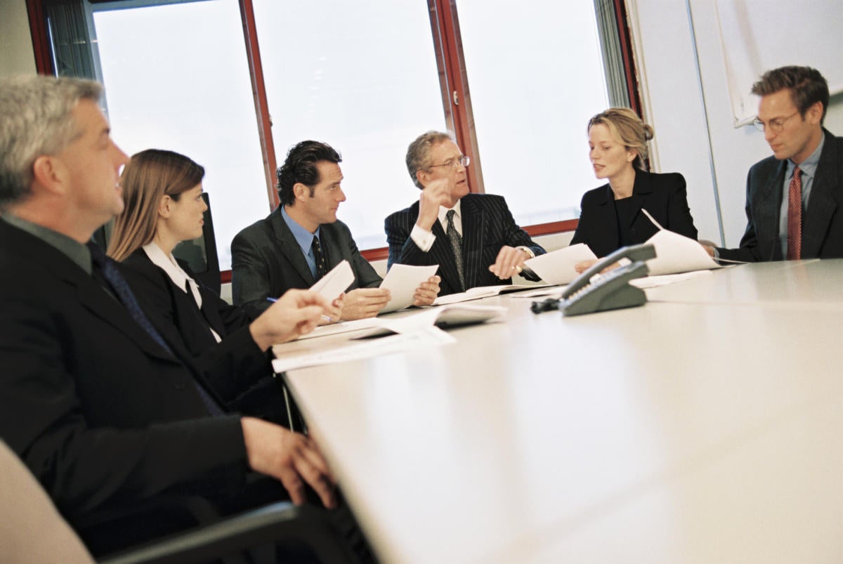 executives sitting in board room at conference table