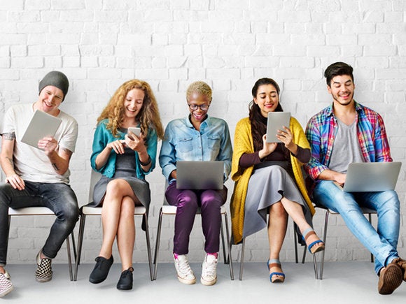 group of millennials using mobile devices