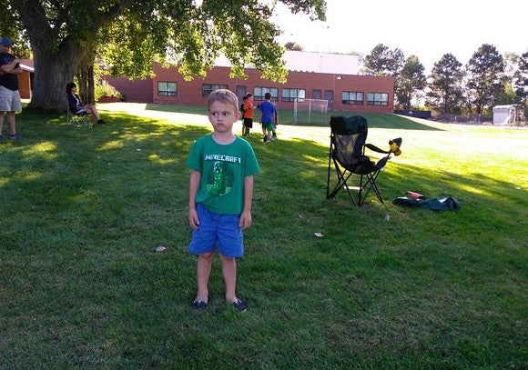 moto g4 play kid standing alone goofy look on face