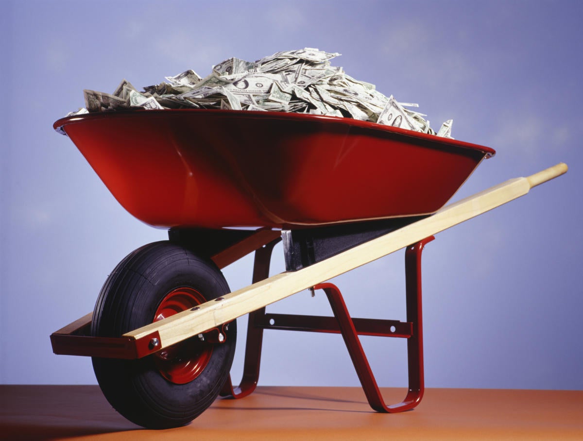 Red wheel barrow filled with money