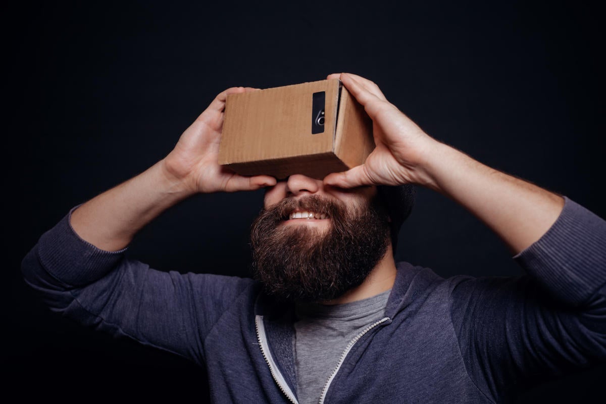 Hipster millennial holding a homemade virtual reality mask