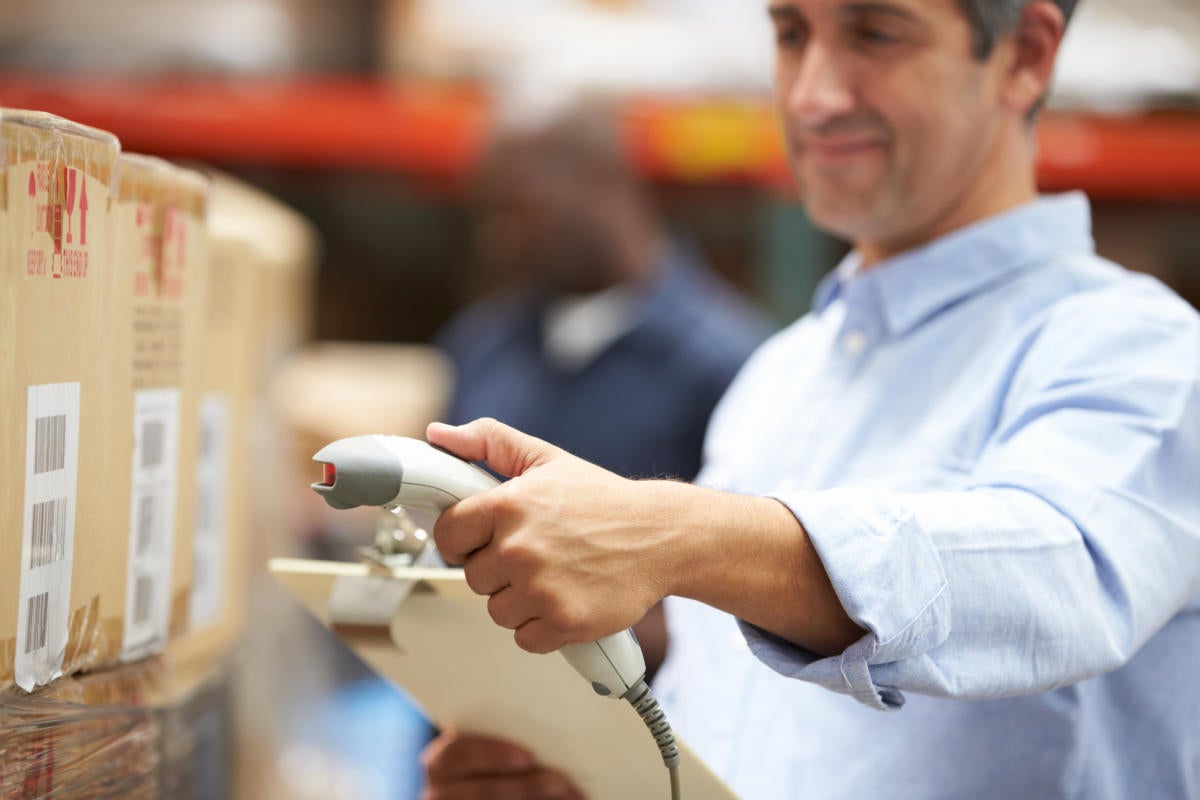 man scanning products in warehouse
