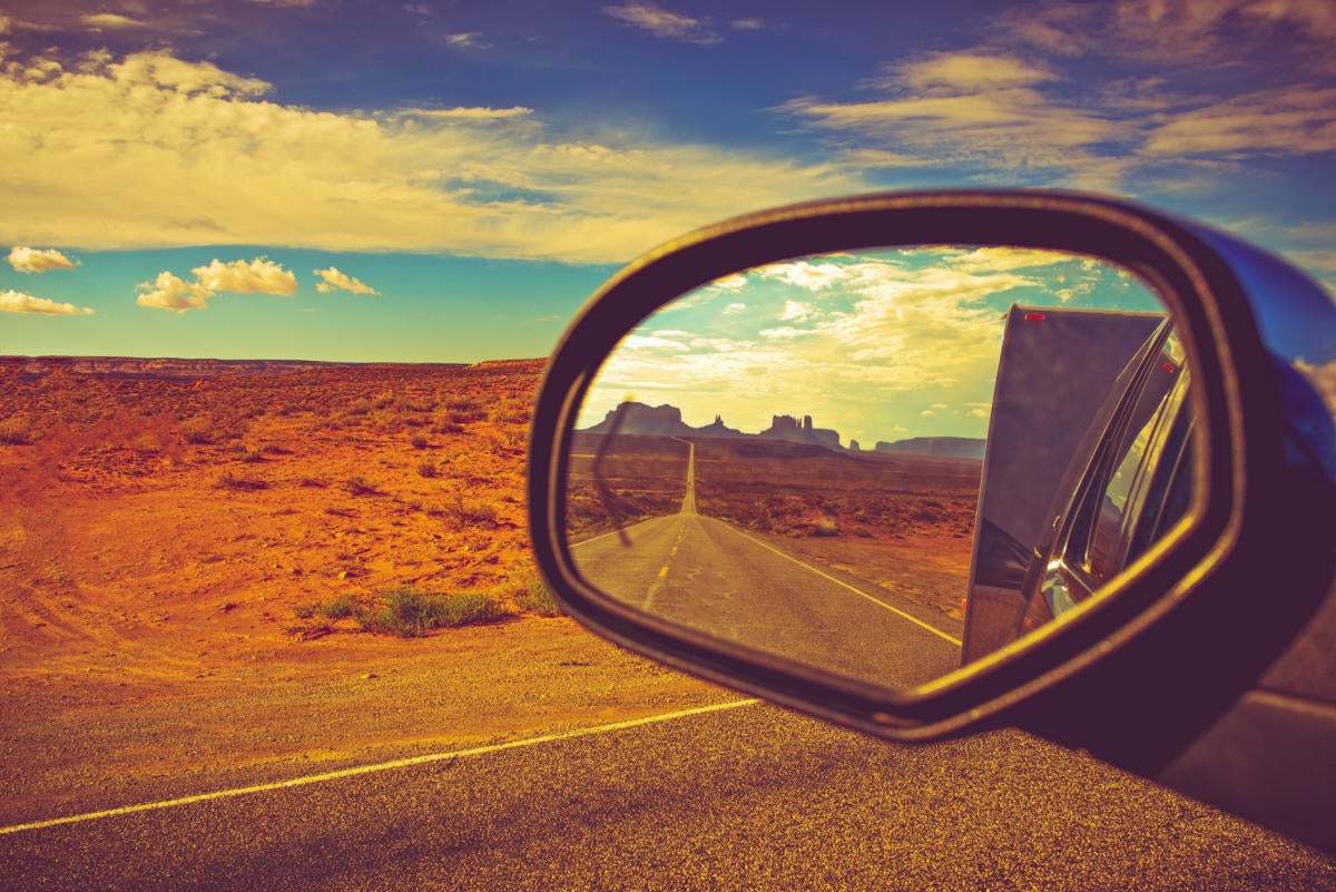 rear view mirror with desert scene in the distance